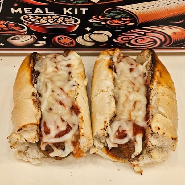 Two meatball subs with melted cheese and sauce, against a meal kit graphic background.